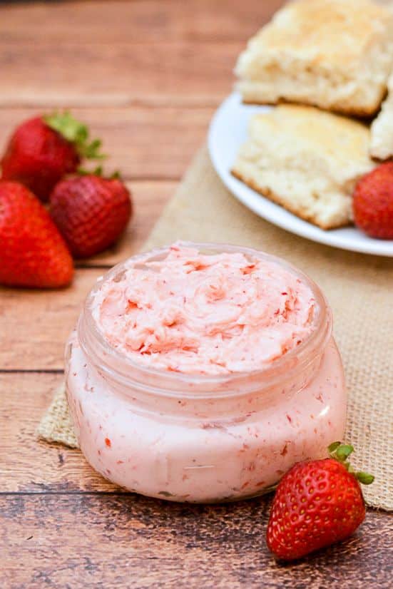 A glass full of sweet strawberries and mint in a spread.
