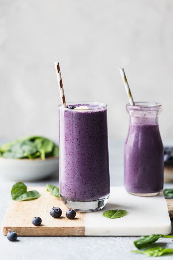 Glasses of creamy blueberries with vegan yogurt.