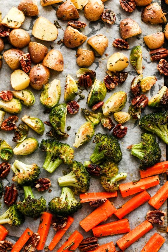 Baked spiced vegetables on a baking sheet.