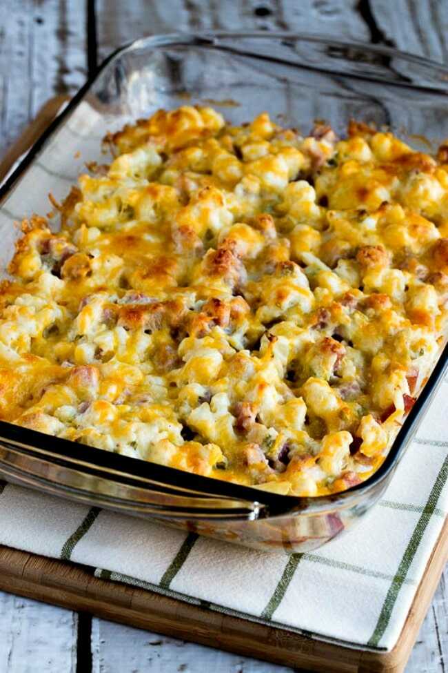 Baked cauliflower with ham and cheese in a baking dish.