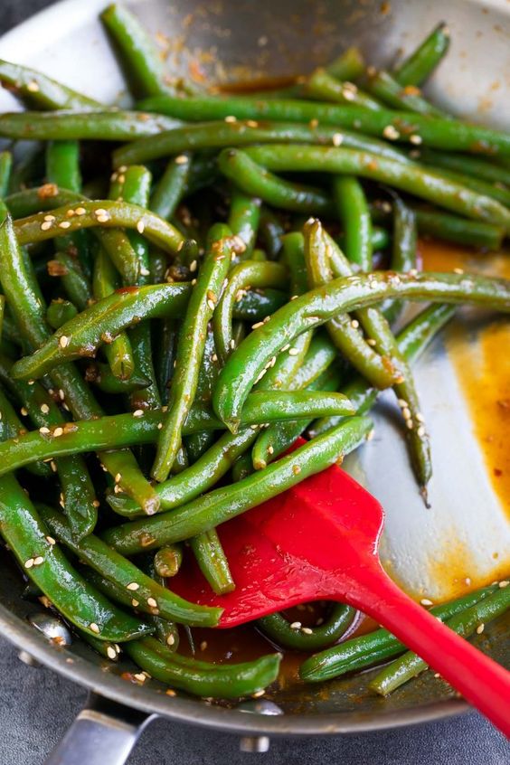 Crispy green beans with sesame in sour sauce.