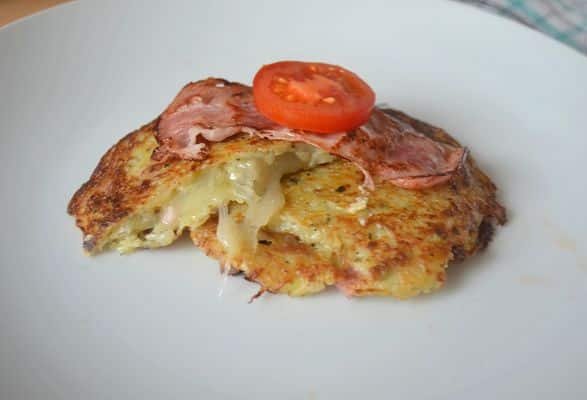 Potatoes stuffed with cheese, decorated with a slice of bacon and tomato.