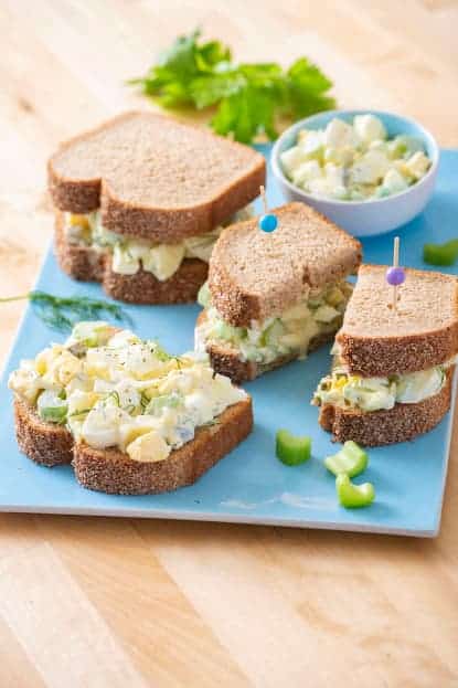 Egg salad spread on slices of bread.