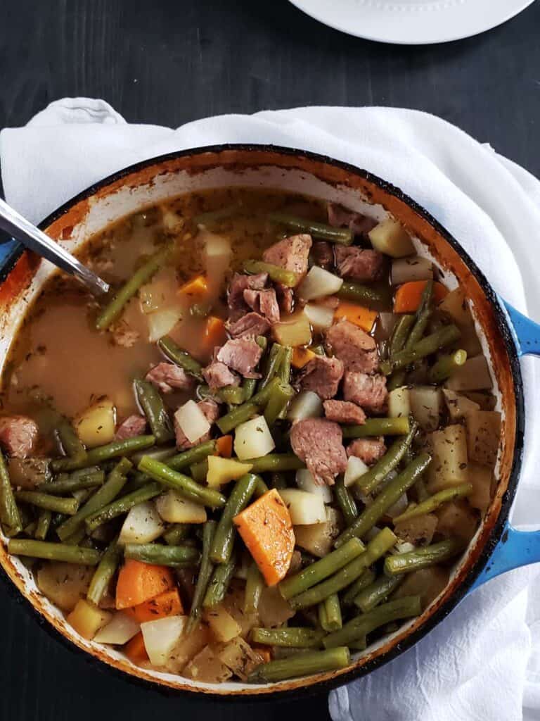 Steamed mixture with meat and vegetables in a pot.