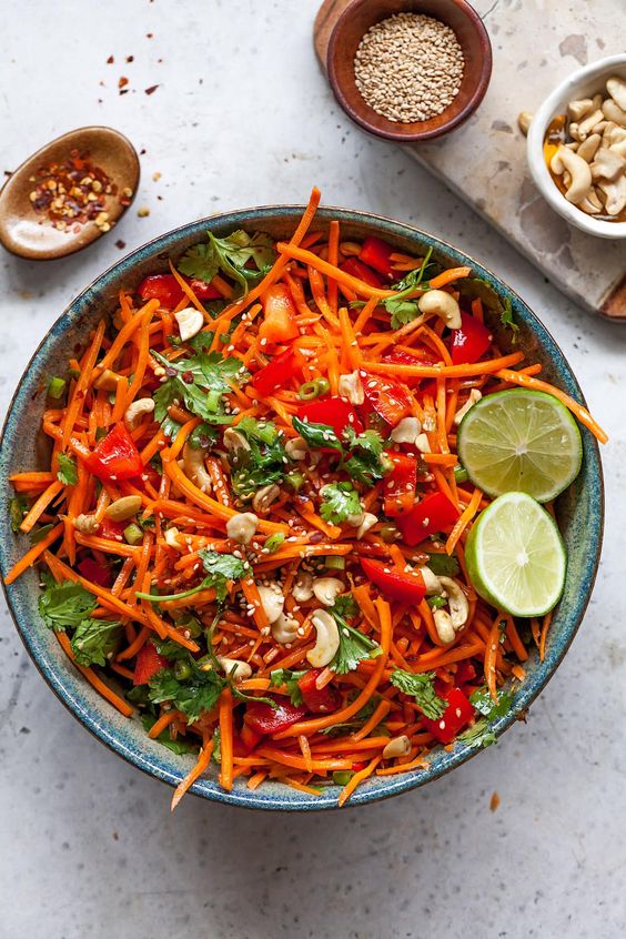 Carrots cut into strips with cashew nuts and lime.