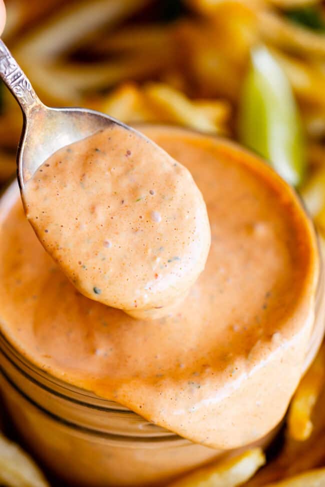 Chipotle mayonnaise in a jar, scooped with a spoon.