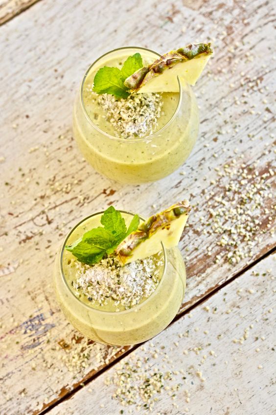 Glasses full of delicious smoothie with pineapple and seeds.