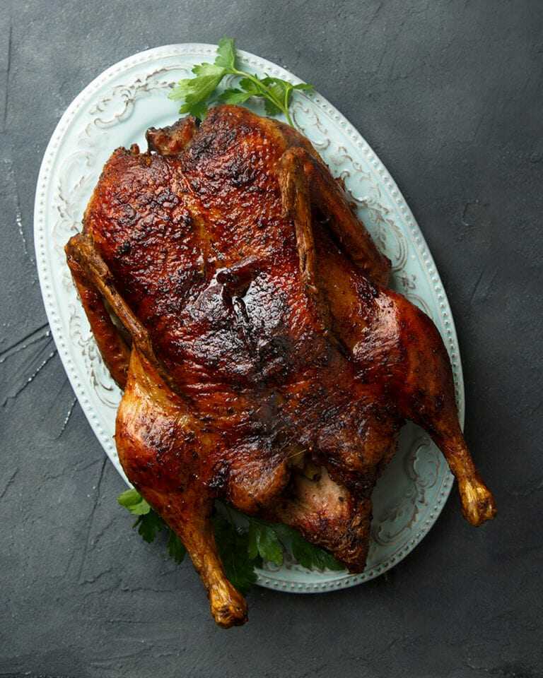 Baked duck on a large plate.