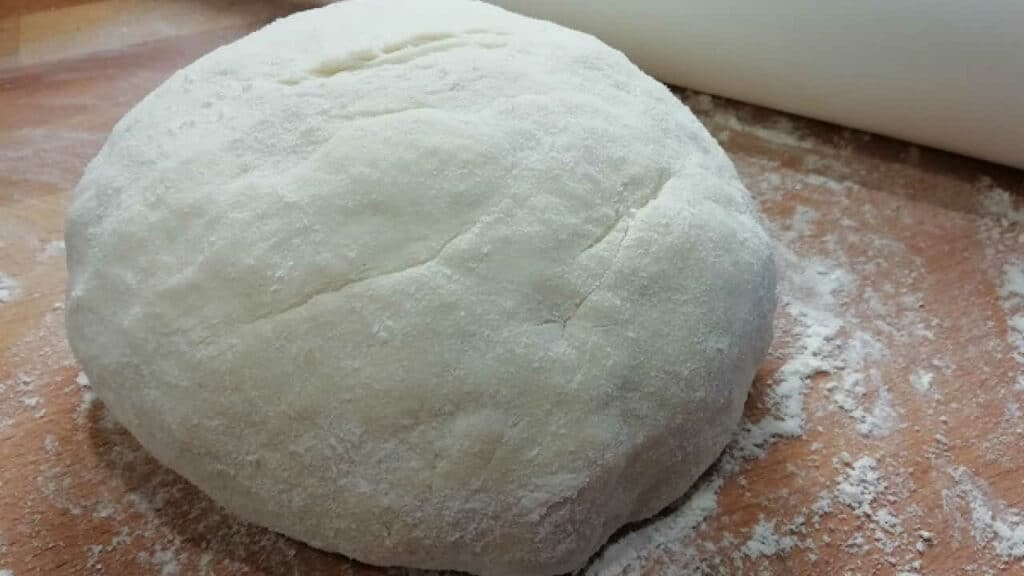Cottage cheese dough on a floured work surface.