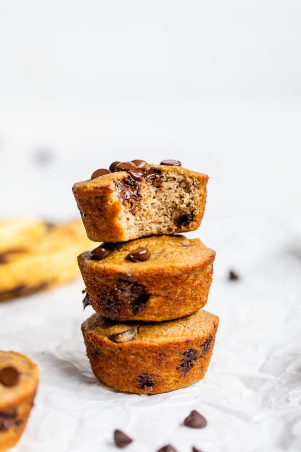 Banana, coconut flour and chocolate muffins stacked on top of each other.