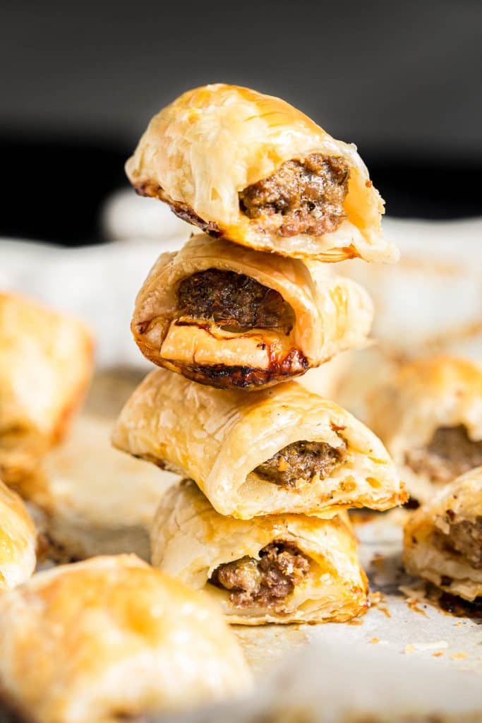 Meat rolls in puff pastry stacked on top of each other.