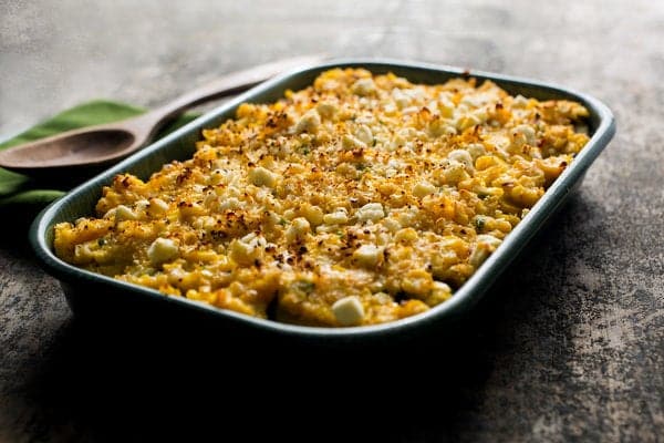 Baked beans with zucchini and corn in a baking dish.