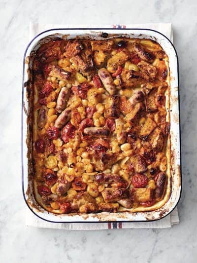 Baked white beans with sausage in a baking dish.
