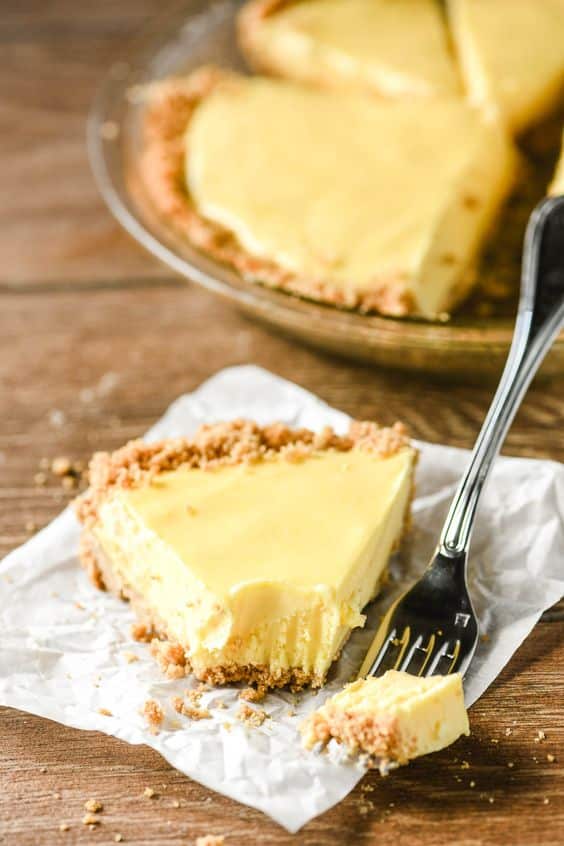 A triangle of fresh lemon pie with a delicious crust.