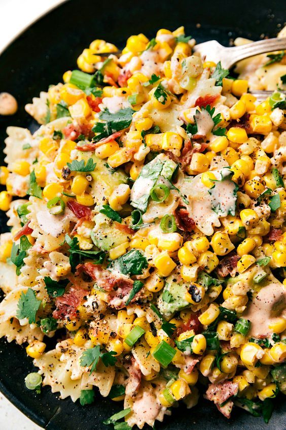 Bow pasta salad with corn and onion.