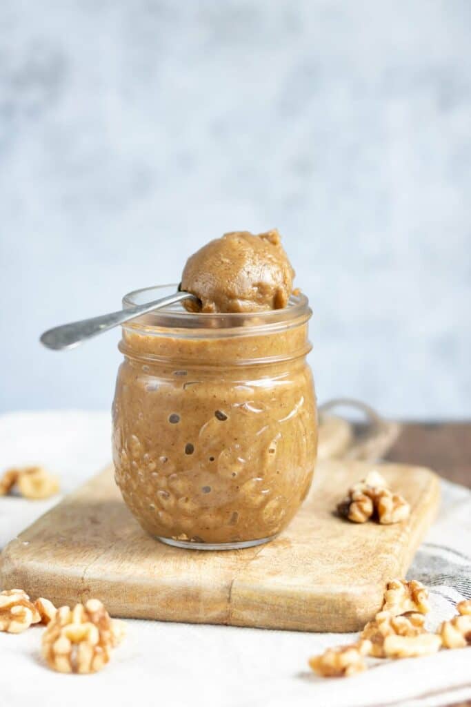Nut butter in a jar with a spoon.
