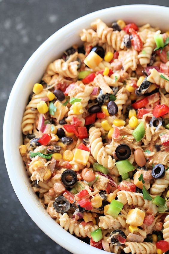 Delicious pasta mixed with vegetables and olives.