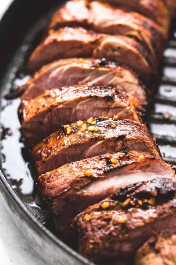 Sliced grilled pork tenderloin with marinade.
